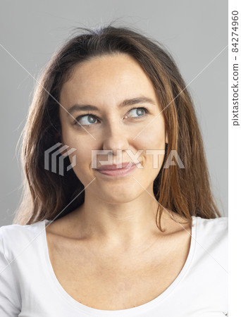 Portrait of young woman with facial expression . 84274960