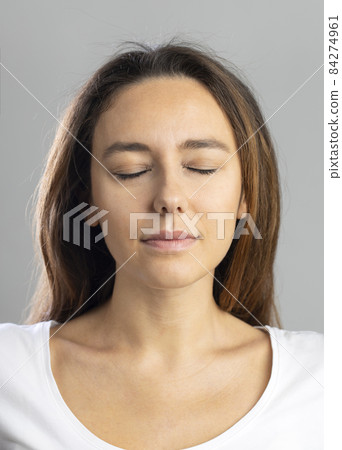 Young woman with calm facial expression 84274961