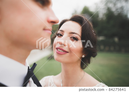Sensual portrait of a young wedding couple. Outdoor 84275641