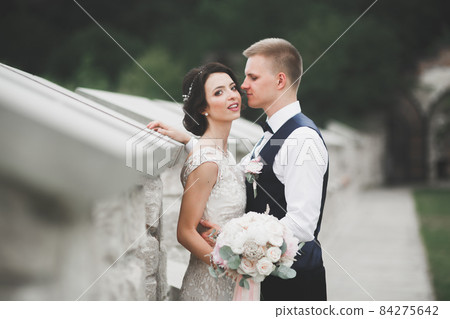 Sensual portrait of a young wedding couple. Outdoor 84275642