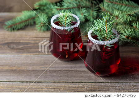 Cranberry red drink decorated with fir tree branches berry and sugar. Christmas hot mulled wine 84276450