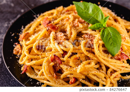 Homemade  pasta with pancetta, egg, hard parmesan cheese and cream sauce 84276647