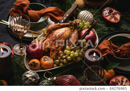 Festive dinner with whole roasted chicken and 84276965