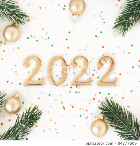 Square image with numbers 2022 and Christmas decorations, confetti Square image with numbers 2022 and Christmas decorations, confetti 84277609