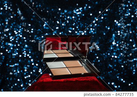 highlighter palette on red velvet podium on blue sequin background highlighter palette on red velvet podium on blue sequin background 84277735