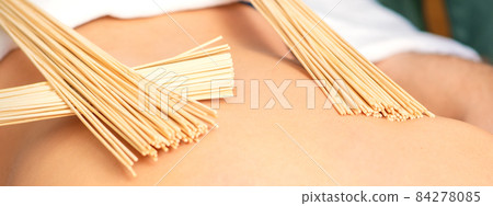 Young woman have double samurai massage with bamboo brooms in spa. Relaxation massage concept. Young woman have double samurai massage with bamboo brooms in spa. Relaxation massage concept. 84278085