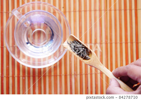 Dry tea leaves on spoon close up . Dry tea leaves on spoon close up . 84278710