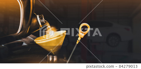 Mechanic pouring motor oil to engine with copy space on black background,Double exposure concept Mechanic pouring motor oil to engine with copy space on black background,Double exposure concept 84279013