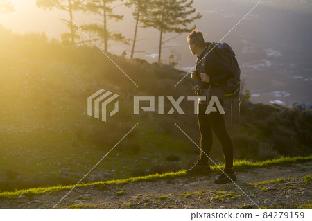 A traveler is hiking and looking on beautiful view. A traveler is hiking and looking on beautiful view. 84279159