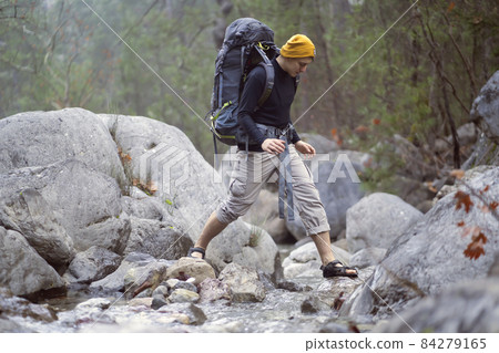 A young smiley man with a backpack  84279165