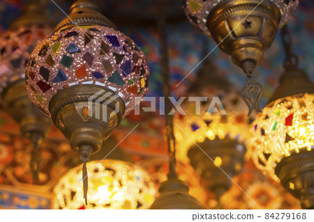 Middle Eastern lambas of different colors and sizes are hanging in the bazaar. Middle Eastern lambas of different colors and sizes are hanging in the bazaar. 84279168