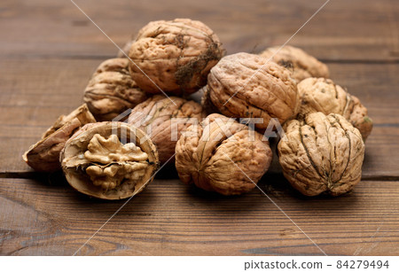 walnut on brown wooden table, close up walnut on brown wooden table, close up 84279494