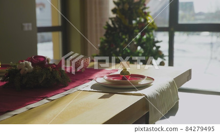 Preparing for Christmas, serving a festive table in the house. Christmas traditions. 84279495