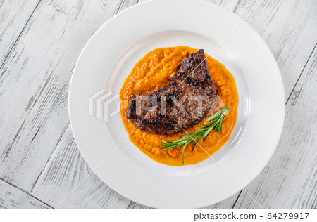Beef steak with mashed pumpkin 84279917
