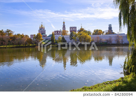 View of the Novodevichy convent (Bogoroditse-Smolensky monastery) and the big Novodevichy pond on a sunny autumn day. Moscow, Russia. UNESCO world heritage site View of the Novodevichy convent (Bogoroditse-Smolensky monastery) and the big Novodevichy pond on a sunny autumn day. Moscow, Russia. UNESCO world heritage site 84280094