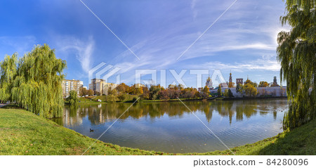 View of the Novodevichy convent (Bogoroditse-Smolensky monastery) and the big Novodevichy pond on a sunny autumn day(panoramic view). Moscow, Russia. UNESCO world heritage site View of the Novodevichy convent (Bogoroditse-Smolensky monastery) and the big Novodevichy pond on a sunny autumn day(panoramic view). Moscow, Russia. UNESCO world heritage site 84280096