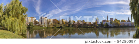 View of the Novodevichy convent (Bogoroditse-Smolensky monastery) and the big Novodevichy pond on a sunny autumn day(panoramic view). Moscow, Russia. UNESCO world heritage site View of the Novodevichy convent (Bogoroditse-Smolensky monastery) and the big Novodevichy pond on a sunny autumn day(panoramic view). Moscow, Russia. UNESCO world heritage site 84280097