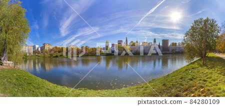 View of the Novodevichy convent (Bogoroditse-Smolensky monastery) and the big Novodevichy pond on a sunny autumn day(panoramic view). Moscow, Russia. UNESCO world heritage site View of the Novodevichy convent (Bogoroditse-Smolensky monastery) and the big Novodevichy pond on a sunny autumn day(panoramic view). Moscow, Russia. UNESCO world heritage site 84280109