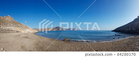 Panorama image of a beach or bay on the atlantic ocean with sand, grass, waves, high rocks and a blue sky with clouds on a sunny day in summer Panorama image of a beach or bay on the atlantic ocean with sand, grass, waves, high rocks and a blue sky with clouds on a sunny day in summer 84280170