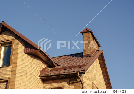 The brown roof with mantel chimney of a beautiful modern stone m The brown roof with mantel chimney of a beautiful modern stone m 84280361