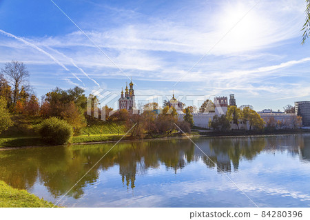View of the Novodevichy convent (Bogoroditse-Smolensky monastery) and the big Novodevichy pond on a sunny autumn day. Moscow, Russia. UNESCO world heritage site View of the Novodevichy convent (Bogoroditse-Smolensky monastery) and the big Novodevichy pond on a sunny autumn day. Moscow, Russia. UNESCO world heritage site 84280396