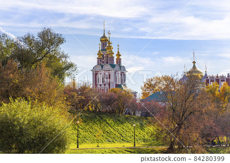 View of the Novodevichy convent (Bogoroditse-Smolensky monastery) and the big Novodevichy pond on a sunny autumn day. Moscow, Russia. UNESCO world heritage site View of the Novodevichy convent (Bogoroditse-Smolensky monastery) and the big Novodevichy pond on a sunny autumn day. Moscow, Russia. UNESCO world heritage site 84280399