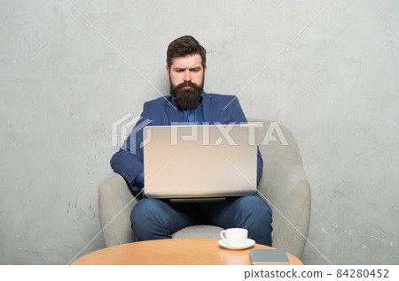 Businessman work laptop. Man drink coffee in business Businessman work laptop. Man drink coffee in business 84280452