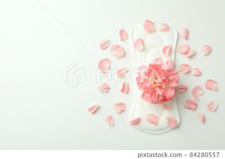 Hygiene pad with flower and petals on white background Hygiene pad with flower and petals on white background 84280557