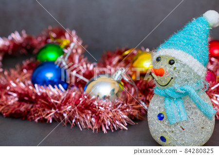 Toy snowman on the background of Christmas decorations 84280825