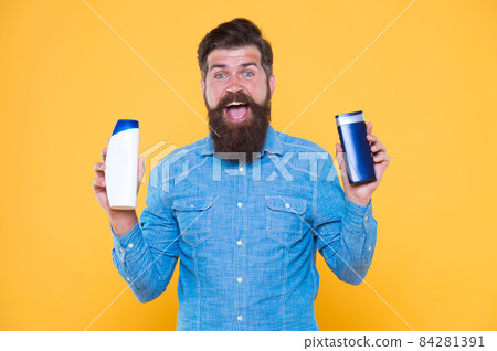 Grooming at every opportunity. Bearded man hold shampoo care. Grooming products for men Grooming at every opportunity. Bearded man hold shampoo care. Grooming products for men 84281391