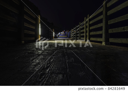 wooden walkway near the coastline at night in Alicante, Spain wooden walkway near the coastline at night in Alicante, Spain 84281649