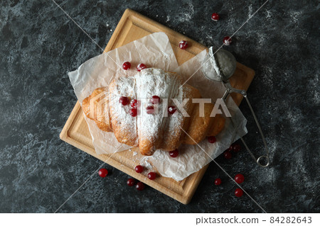 Concept of tasty food with croissant on dark background Concept of tasty food with croissant on dark background 84282643