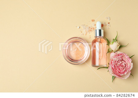 Skin care concept with essential rose oil on beige background, space for text 84282674