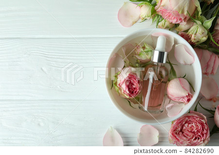 Skin care concept with essential rose oil on white wooden table 84282690