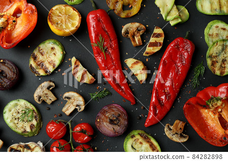 Tasty grilled vegetables on black background, top view Tasty grilled vegetables on black background, top view 84282898