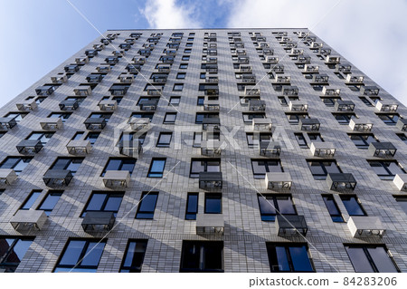 Moderne multy-storey apartment facade of residential building. The view from the top down. Moderne multy-storey apartment facade of residential building. The view from the top down. 84283206