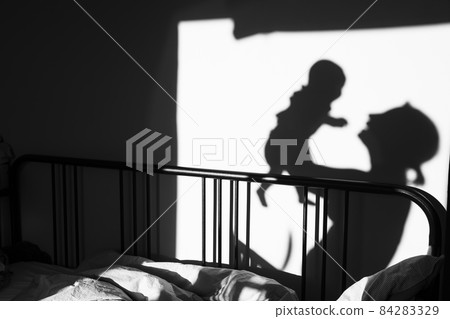 silhouette of a child and parent who are playing in the room in the morning. silhouette of a child and parent who are playing in the room in the morning. 84283329
