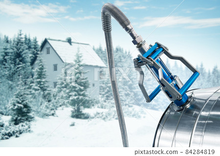 CNG nozzle with gas tank on a background of winter house CNG nozzle with gas tank on a background of winter house 84284819