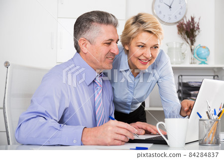 Colleagues look interesting in computer 84284837