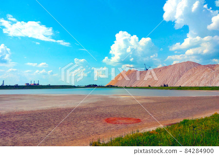 Large mountains of waste ore. Extraction of salt. Minerals. Industry concept. 84284900