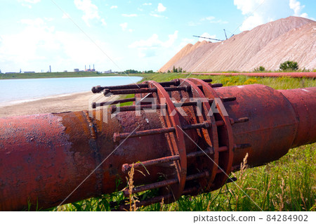 Close-up of a rusty large production pipe. 84284902