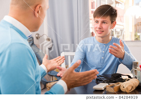 Man and his son talking at home Man and his son talking at home 84284919