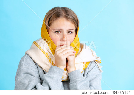 Half-length portrait of young beautiful girl in warm winter clothes isolated on navy color studio background in neon light. Half-length portrait of young beautiful girl in warm winter clothes isolated on navy color studio background in neon light. 84285195