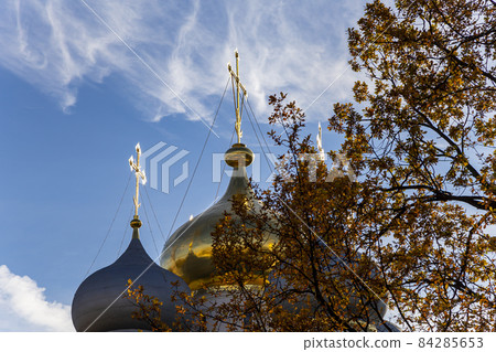 Novodevichy convent (Bogoroditse-Smolensky monastery) on a sunny day. The domes of the Cathedral of Our Lady of Smolensk (16th century). Moscow, Russia. UNESCO world heritage site 84285653