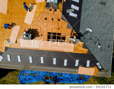 Removal of old roof and replacement roofs with new roof shingle being applied home roof construction all new materials. 84285751
