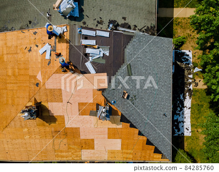 Roof shingles need with new shingles of an apartment building replacing gray asphalt tile Roof shingles need with new shingles of an apartment building replacing gray asphalt tile 84285760