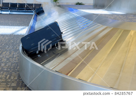 Carousel with luggage at arrival area of passenger terminal 84285767