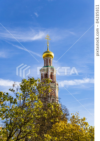 Novodevichy convent (Bogoroditse-Smolensky monastery) on a sunny autumn day. Octagonal bell-tower. Moscow, Russia. UNESCO world heritage site Novodevichy convent (Bogoroditse-Smolensky monastery) on a sunny autumn day. Octagonal bell-tower. Moscow, Russia. UNESCO world heritage site 84285811