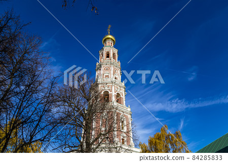 Novodevichy convent (Bogoroditse-Smolensky monastery) on a sunny autumn day. Octagonal bell-tower. Moscow, Russia. UNESCO world heritage site Novodevichy convent (Bogoroditse-Smolensky monastery) on a sunny autumn day. Octagonal bell-tower. Moscow, Russia. UNESCO world heritage site 84285833