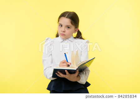 Girl cute schoolgirl in uniform hold book with information Girl cute schoolgirl in uniform hold book with information 84285834